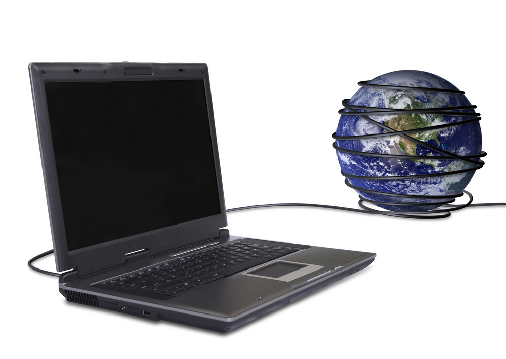 Laptop with cord wrapping around globe